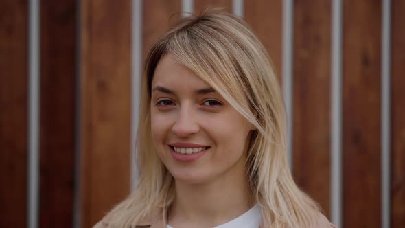 Portrait of a Smiley Blonde Girl Outdoor