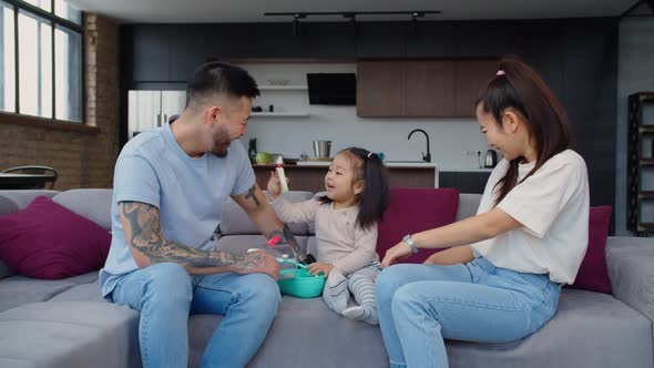 Happy Asian Family Playing in Doctor and Patient with Toys