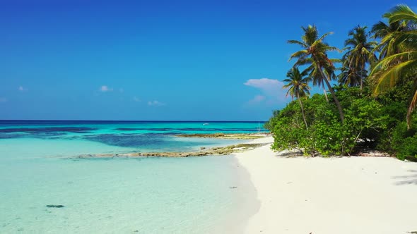 Aerial nature of tranquil tourist beach break by blue ocean and white sandy background of a dayout n