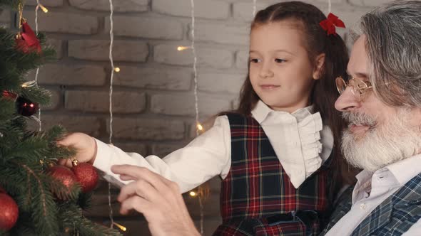 Modern Stylish Grandpa and Kid Decorating Christmas Tree