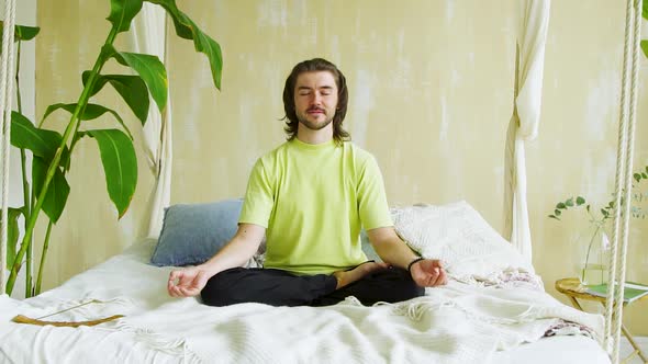 Happy Man in Meditation Pose Sway on Hand Made Bed