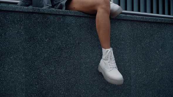 Female Model Legs Sit Posing in Urban Building City Downtown