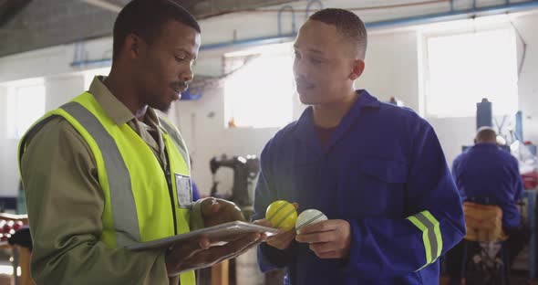 Two colleagues discussing in factory