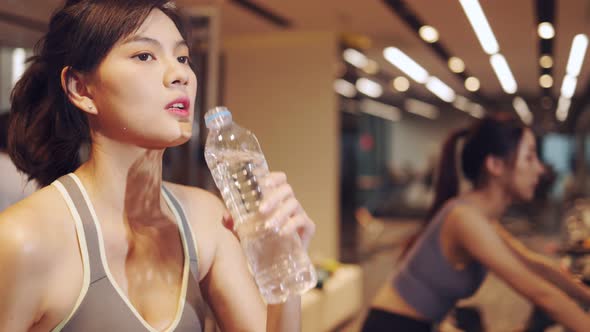 Young beautiful woman asian running on a treadmill at gym. Fitness and healthy lifestyle concept.