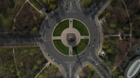 AERIAL: Overhead Birds Eye Drone View Rising Over Berlin Victory Column Roundabout with Little Car