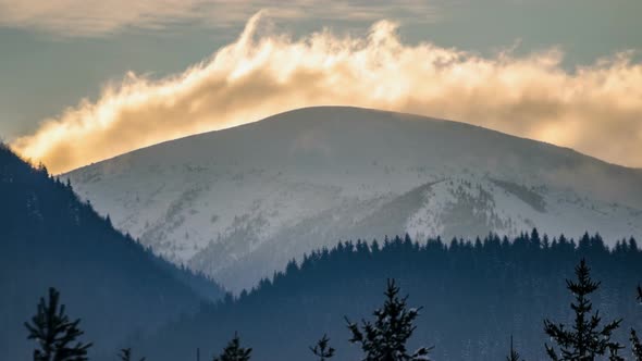 Clouds over Snowy Alpine Peak in Winter Mountains Nature