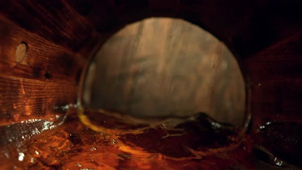 Super Slow Motion Detail Shot of Waving Whiskey in Wooden Barrel at 1000Fps