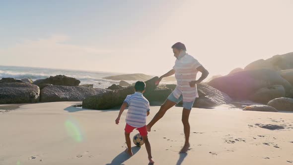 Father and son playing soccer