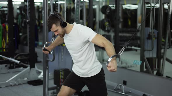 Bodybuilder Guy in Gym Pumping Up Hands Close Up in Headphones