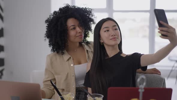 Millennial Roommates Taking Selfie on Smartphone Sitting in Home Office on Lockdown