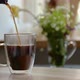 Aromatic Black Coffee is Poured Into Clear Glass Cup Geyser Coffee Maker Slow Motion - VideoHive Item for Sale