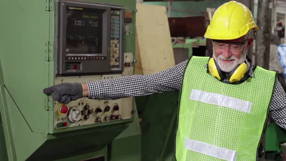 Senior Factory Worker Teach How to Use Machine Equipment in the Factory Workshop