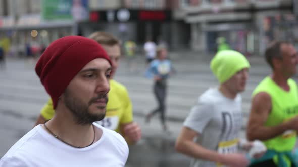 Male Runner on Marathon Race with Running Athletes