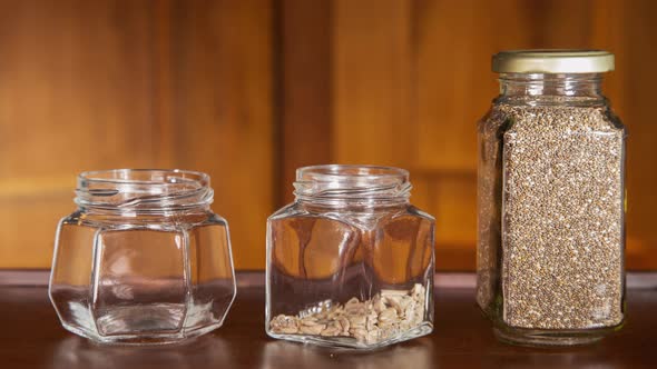 Animation of glass pots with grains emptying out. 