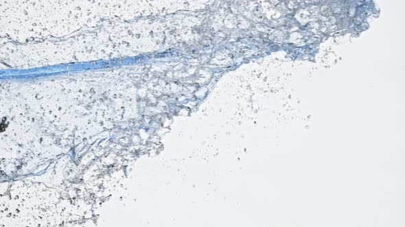 Super Slow Motion Shot of Side Water Splash Isolated on White Background at 1000Fps