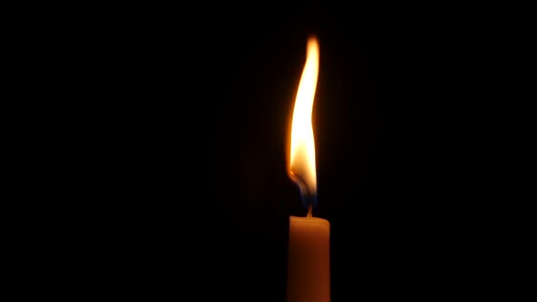 Burning Candle, Isolated on the Black Background. Close Up