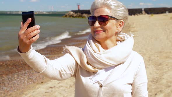 Senior Woman Taking Selfie By Smartphone on Beach