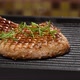 grilled piece of pork with a bone is on the grill and sprinkled with green rosemary - VideoHive Item for Sale