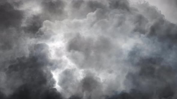 4k point of view, a flash of lightning when a thunderstorm moves inside the dark cumulonimbus cloud.