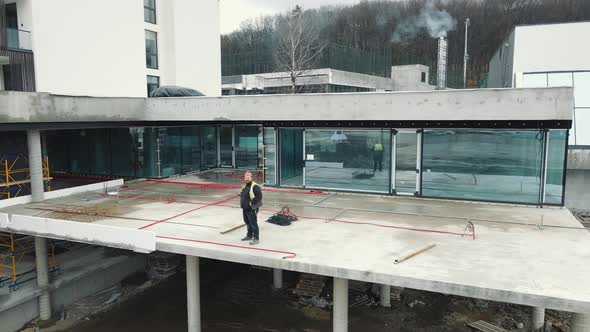 Master Builder Standing on the Construction Balcony and Looking at the Camera