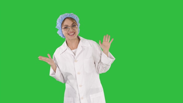 Geek young blonde doctor woman talking to camera on a Green