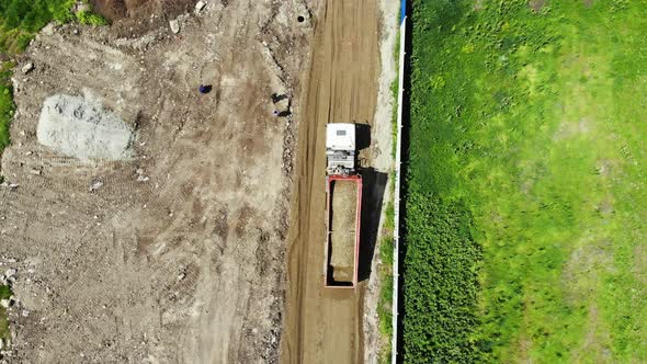 Construction of the road. Dump truck movement.