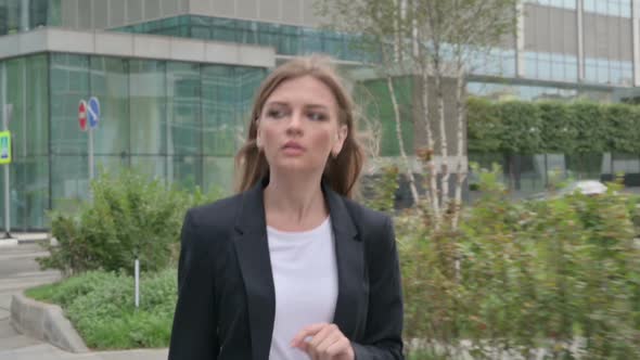 Young Businesswoman Walking on the Street in Slow Motion