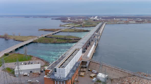 High quality, 4K aerial view of a hydroelectric generating station and distribution power lines.