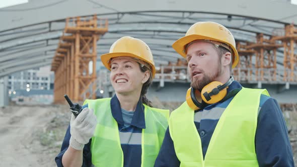 Female and Male Construction Site Workers Talking