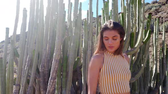 Pretty Model in Yellow-Striped Crop Top in Front of Cacti