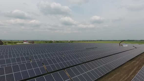 Solar Power Station Construction in the Field Crane is Lowering a Transformer