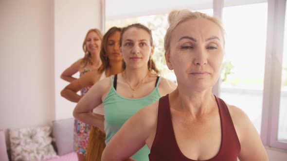 Four Women in Different Ages Do Yoga in the Studio