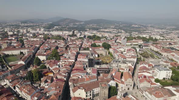 Drone flying over Braga rooftops, Portugal. Aerial forward