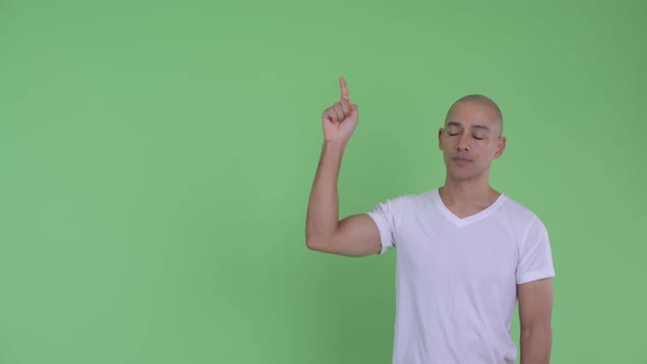 Stressed Bald Man Pointing Up and Giving Thumbs Down