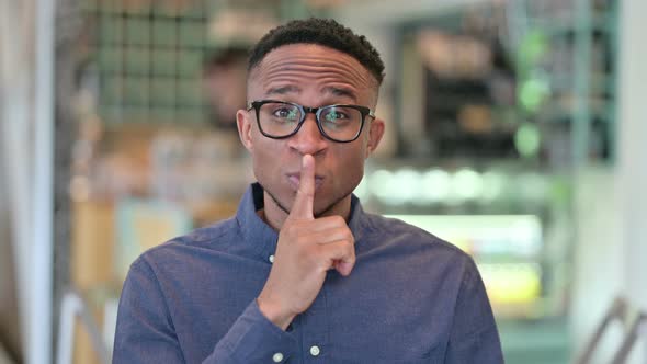 African Man Putting Finger on Lips, Quiet Sign 