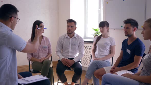 Man Talking and Sharing Emotions During Therapy Session Standing in Circle of People