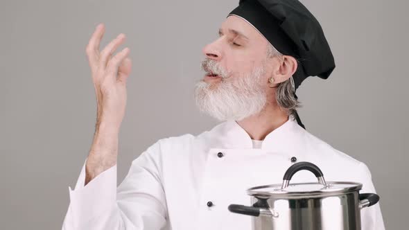 Professional Chef with a Pot on Grey Copy Space