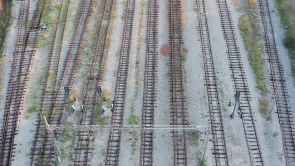 Empty parallel railway tracks in a train station. Rails, ties and ballast of a permanent way