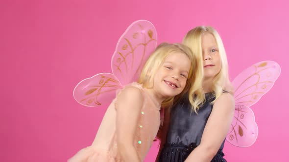 Dressed-Up Twin Sisters Posing and Smiling