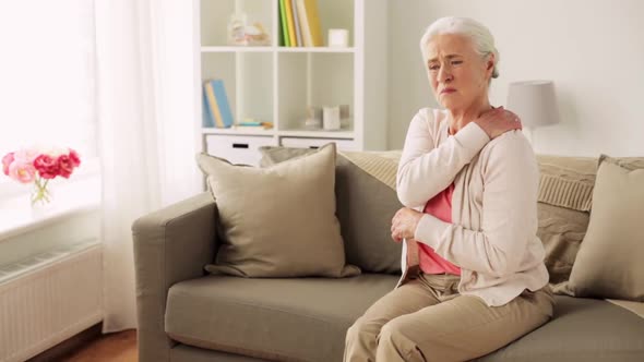 Senior Woman Suffering From Neck Pain at Home