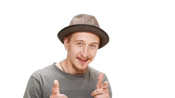 Young Handsome Man in Hat Smiling Over White Background