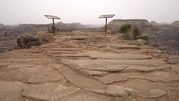 Walking to the edge of an overlook for steep canyon