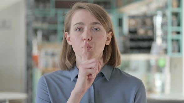 Portrait of Businesswoman Showing Quiet Sign Finger on Lips