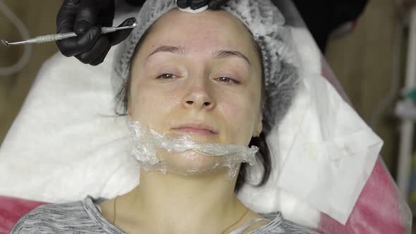 Cosmetologist Make Facial Cleaning Cosmetology Skin Acne Procedure on Woman Face