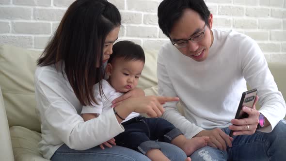 Happy Asian Family Making a Video Call at Home