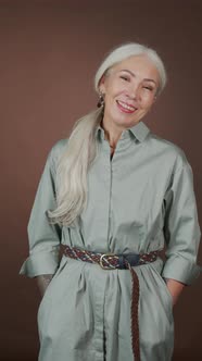 Vertical Portrait of Smiling Mature Woman with Arm Tattoo