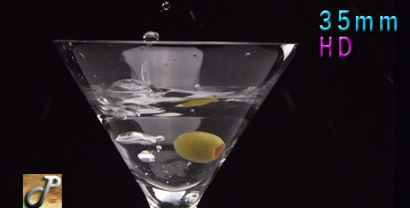 Martini Cocktail Pouring Into Glass With Olive