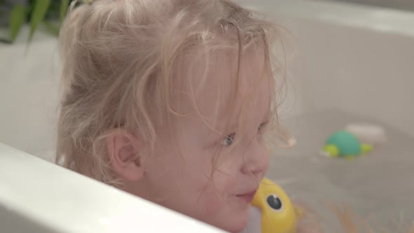 Little Girl Playing with Toys in the Bath