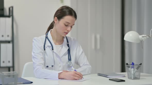 Female Doctor Writing on Paper 