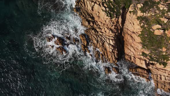 Coastal waves crashing against rocks